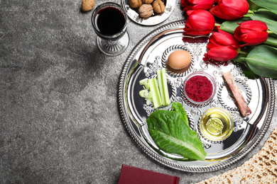 Photo of Flat lay composition with Passover Seder plate (keara) on grey table, space for text. Pesah celebration