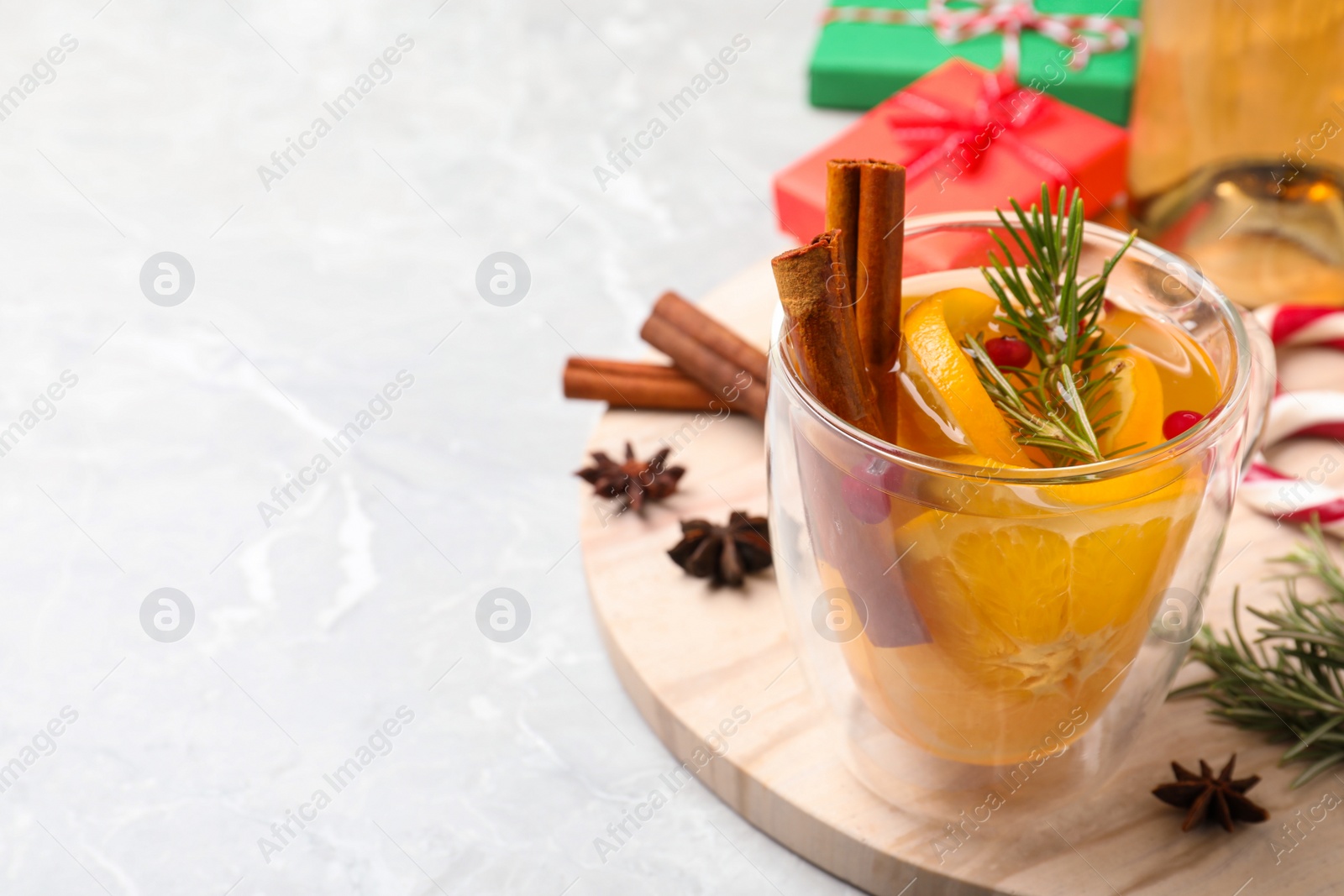 Photo of Aromatic mulled wine on wooden board. Space for text
