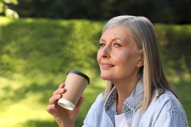 Photo of Portrait of beautiful senior woman with paper cup of coffee outdoors