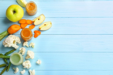 Flat lay composition with baby food and ingredients on wooden background