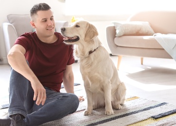 Portrait of owner with his friendly dog at home