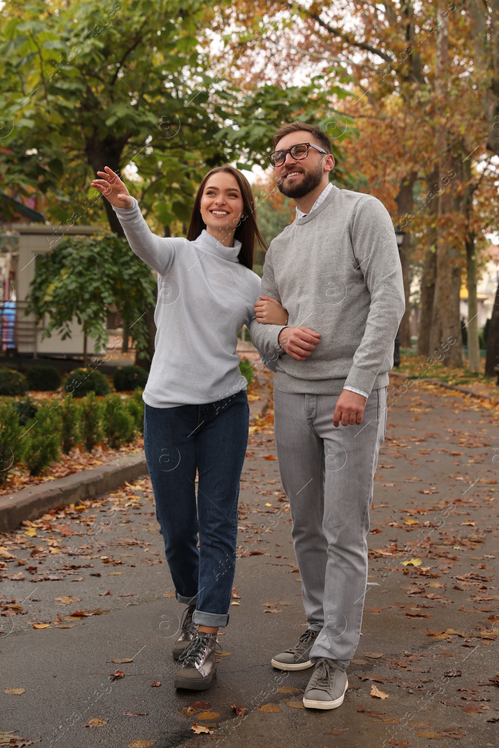 Photo of Happy couple wearing stylish clothes in autumn park