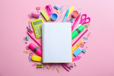 Photo of Bright school stationery on pink background, flat lay. Space for text