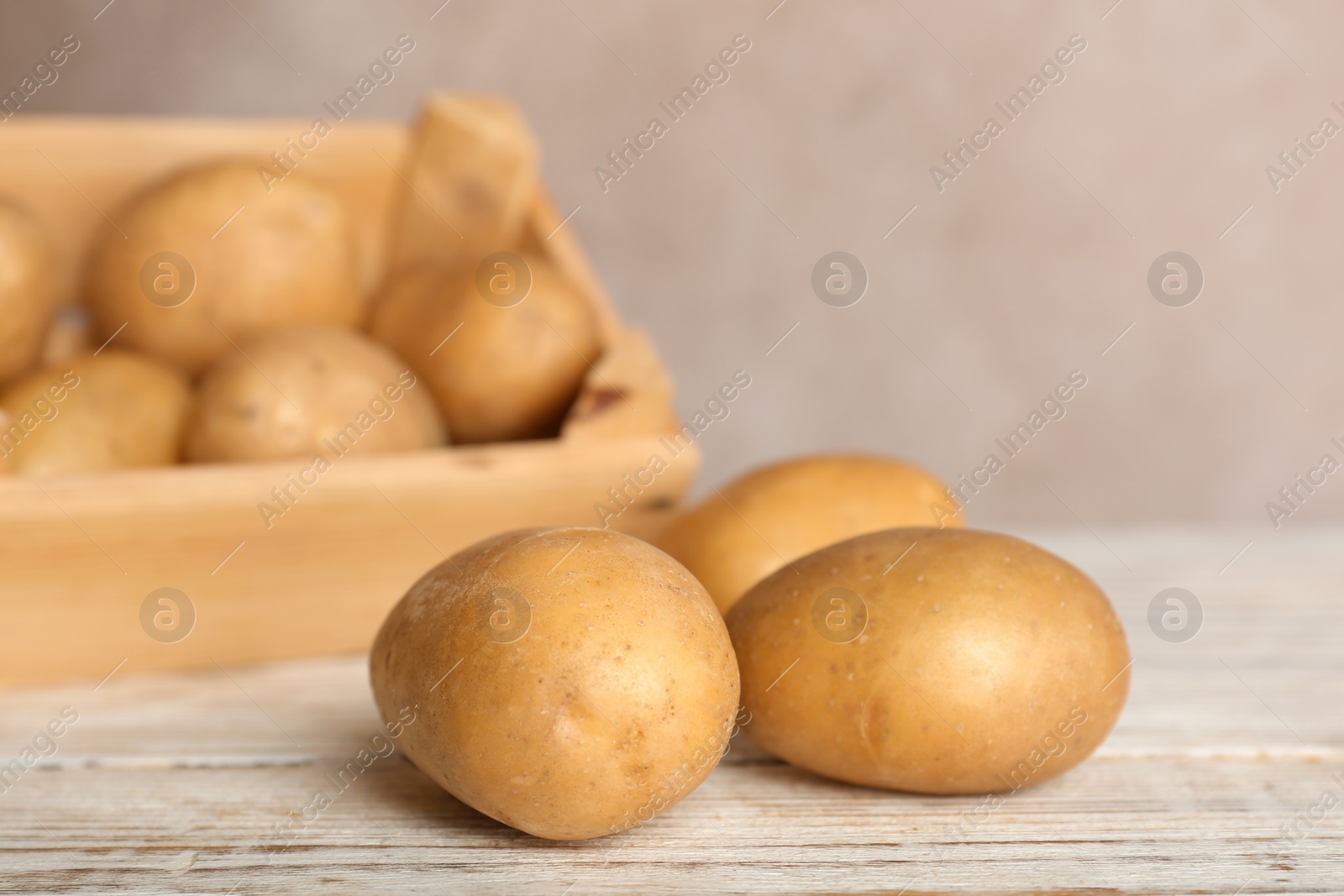 Photo of Fresh ripe organic potatoes on wooden table