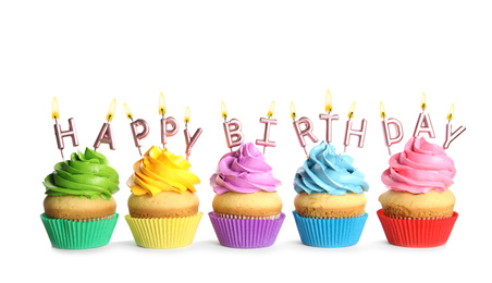 Birthday cupcakes with candles on white background