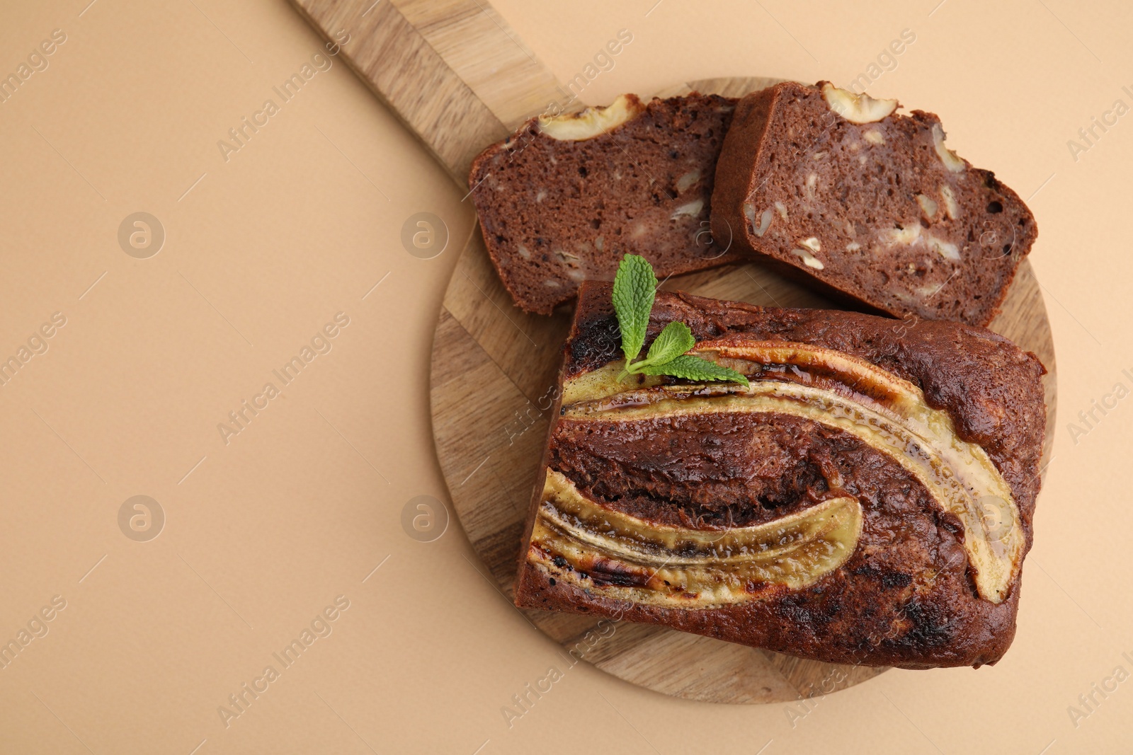 Photo of Delicious banana bread with mint on beige background, top view. Space for text