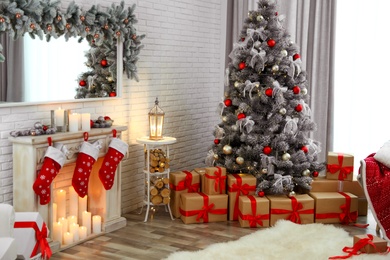 Photo of Beautiful decorated Christmas tree in living room interior