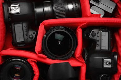 Photo of Professional photography equipment in backpack, top view