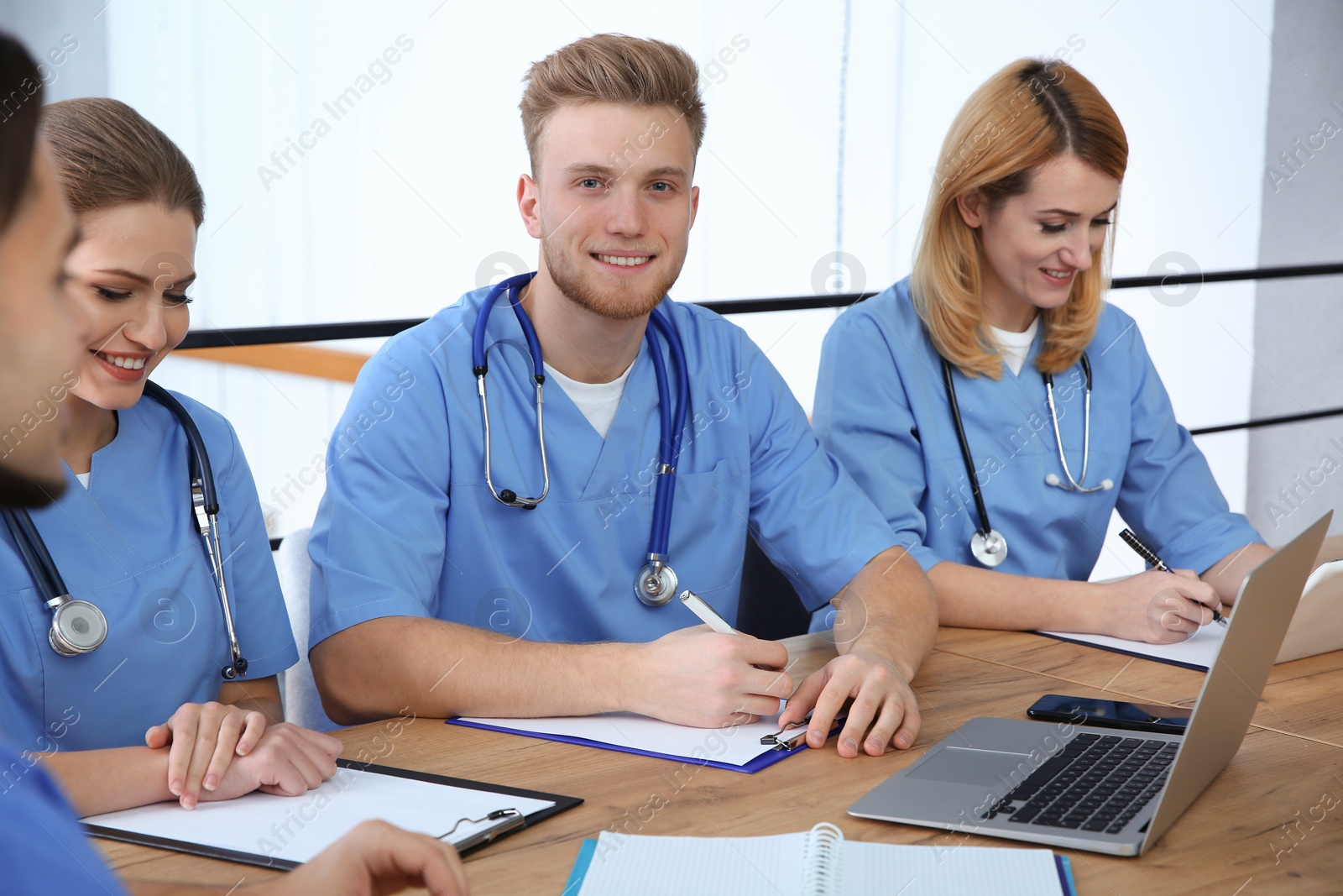 Photo of Medical students in uniforms studying at university