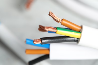 Photo of Colorful electrical wires on blurred background, closeup