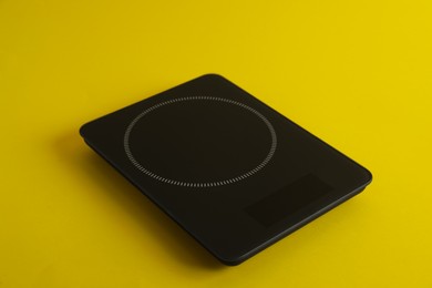 Photo of Modern digital kitchen scale on yellow background