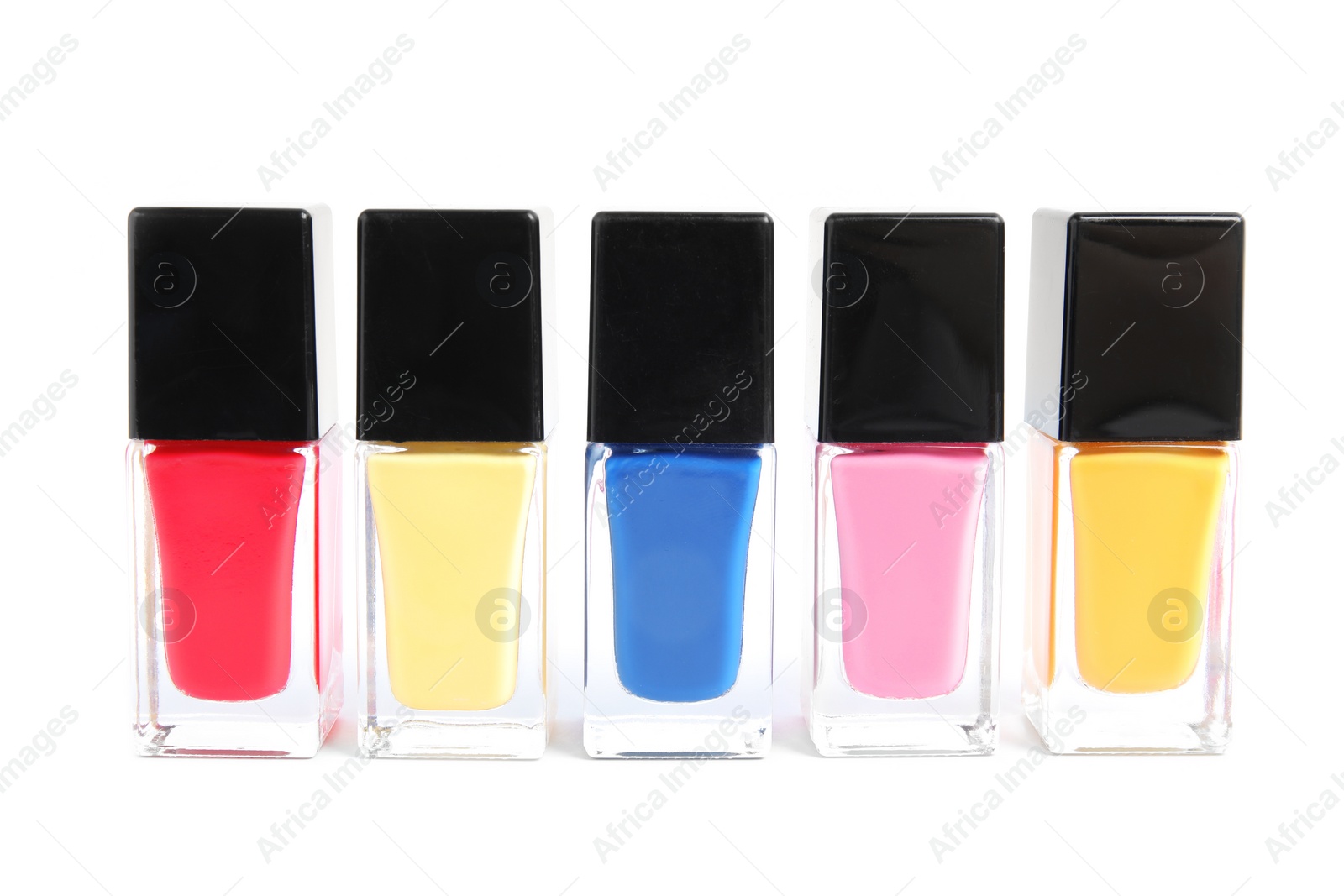 Photo of Bottles of nail polish on white background