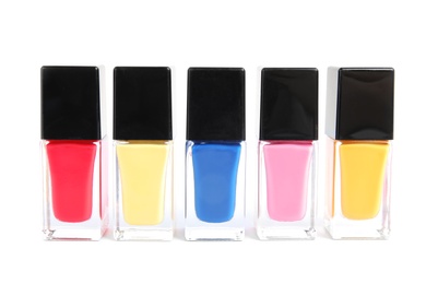 Photo of Bottles of nail polish on white background