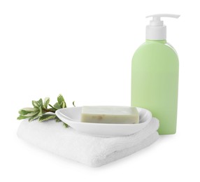 Photo of Dish with soap bar, dispenser and terry towel on white background