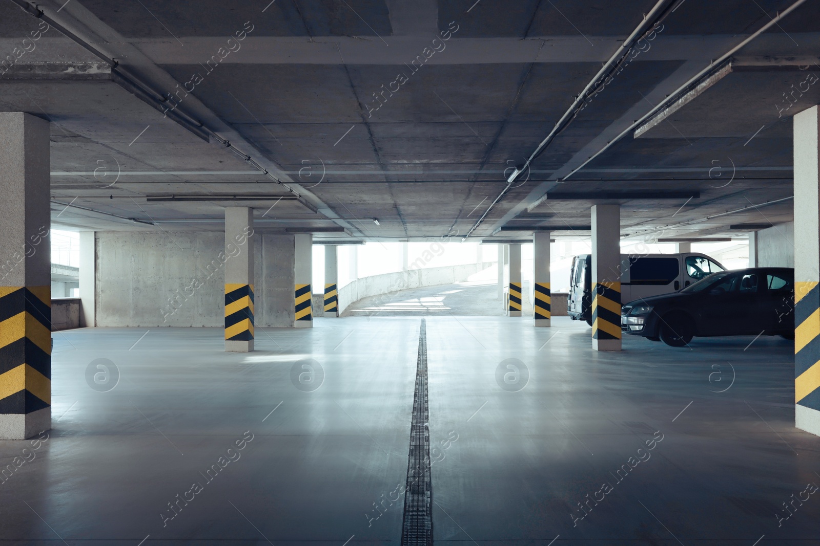 Photo of Open car parking garage with ramp on sunny day