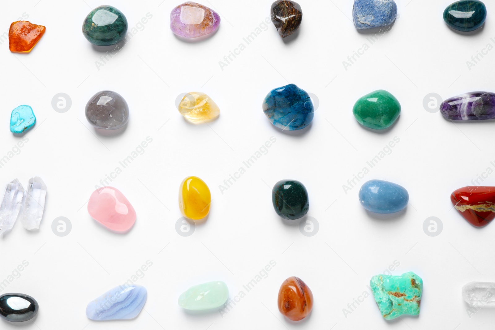 Photo of Different gemstones on white background, top view