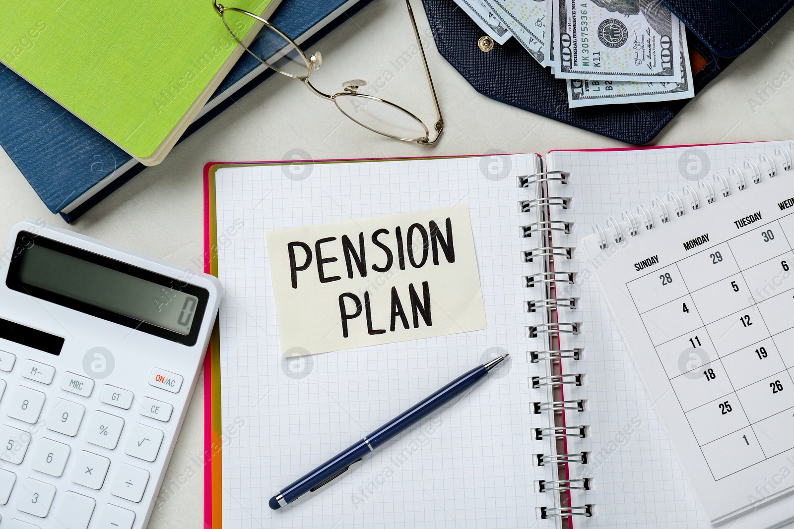 Photo of Card with phrase Pension Plan, dollar banknotes, calculator and notebooks on white office table, flat lay