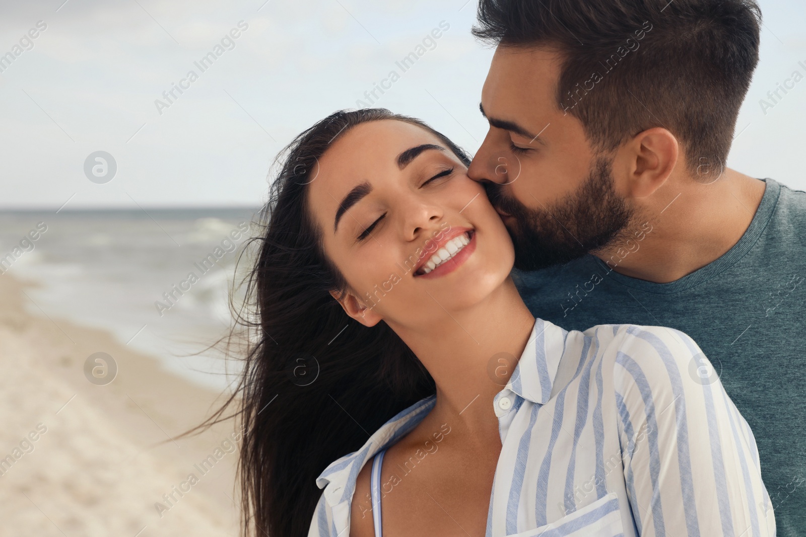 Photo of Lovely couple spending time together on beach