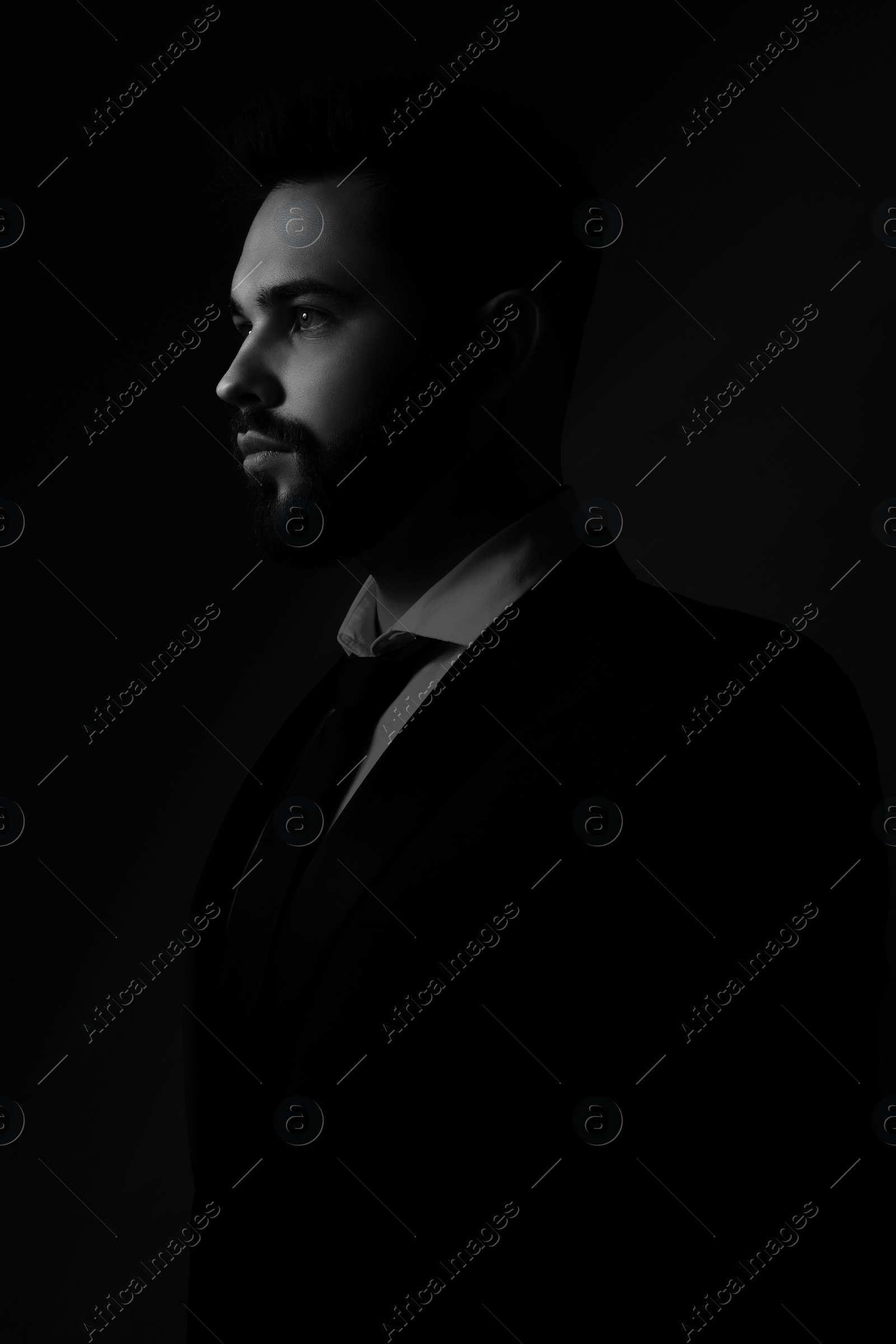 Image of Silhouette of man in darkness. Portrait on black background