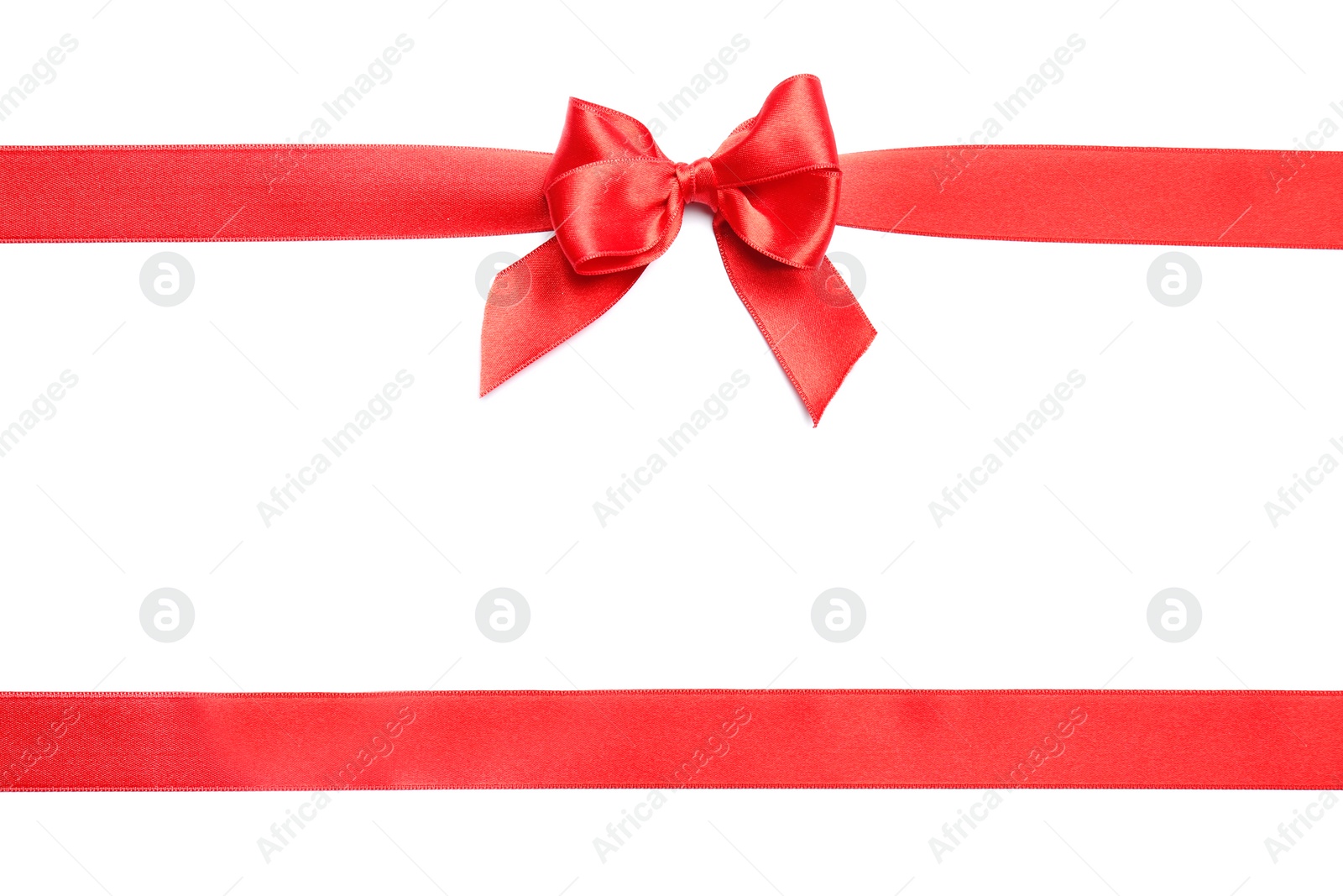 Photo of Red ribbons with bow on white background, top view