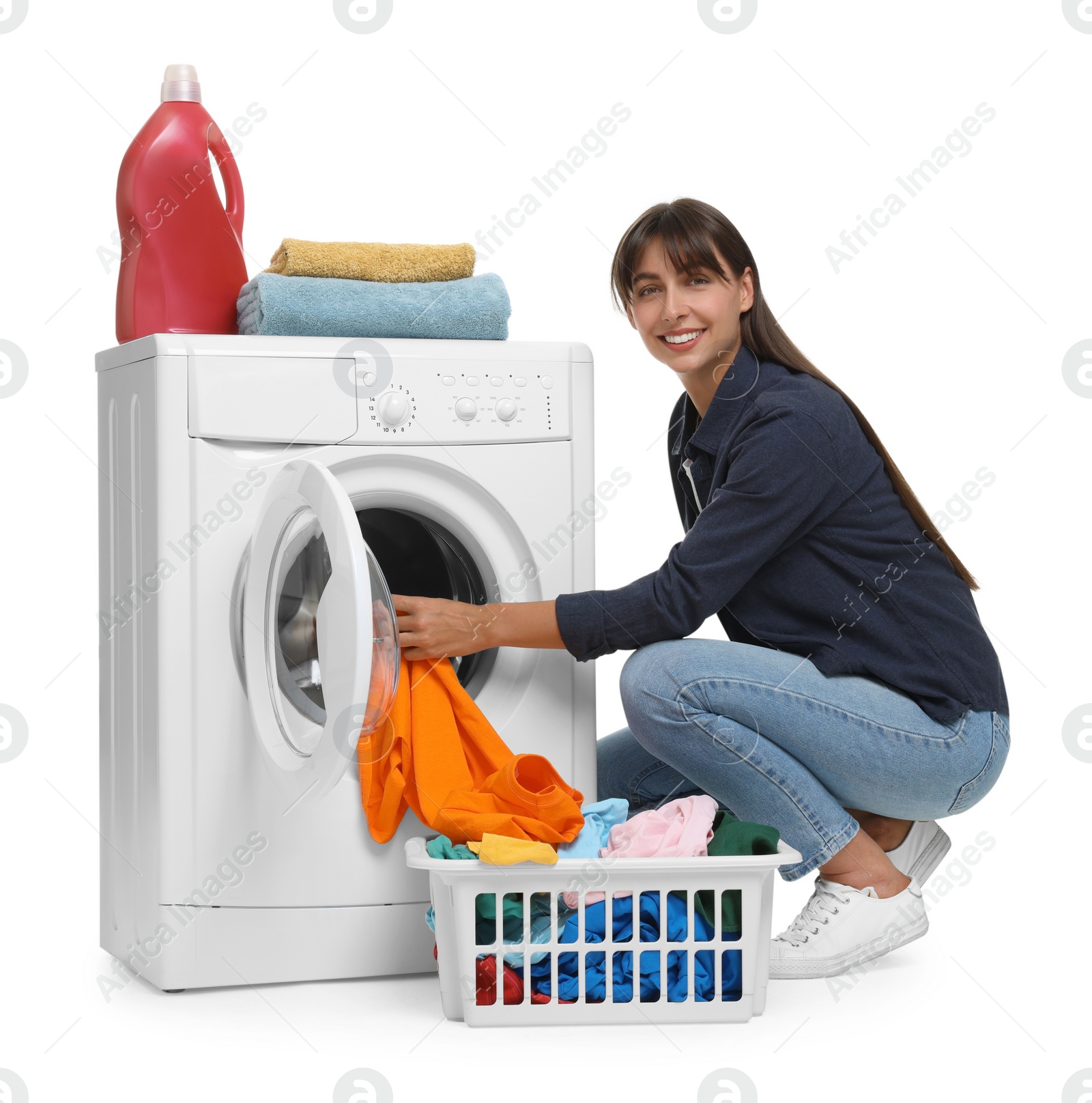 Photo of Beautiful woman taking laundry out of washing machine on white background