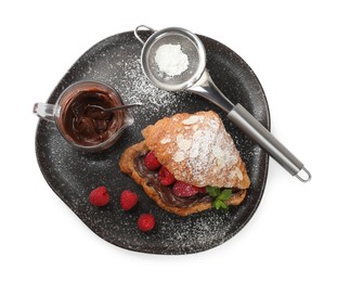 Photo of Delicious croissant with raspberries, chocolate and powdered sugar isolated on white, top view