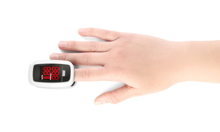Photo of Woman using modern fingertip pulse oximeter on white background, top view
