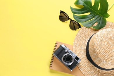 Photo of Flat lay composition with stylish hat, camera and sunglasses on color background