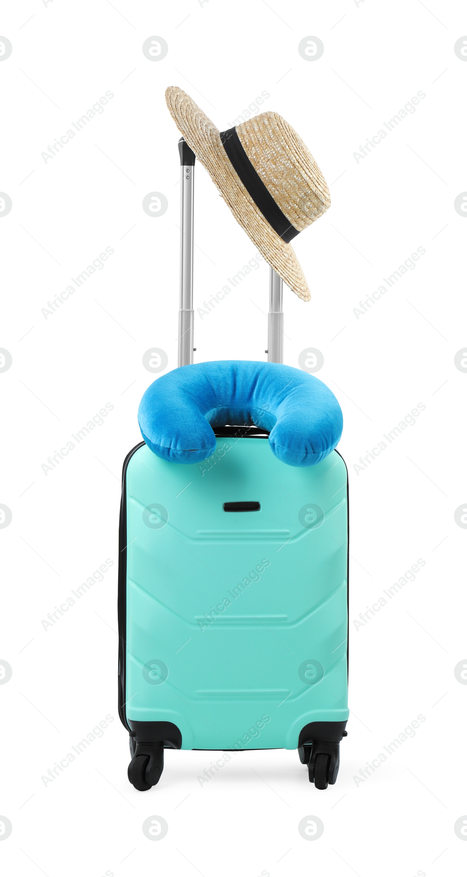 Photo of Soft travel pillow and hat on turquoise suitcase isolated on white