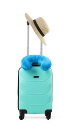 Photo of Soft travel pillow and hat on turquoise suitcase isolated on white