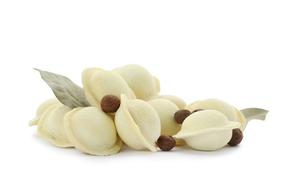 Photo of Raw meat dumplings with bay leaves on white background