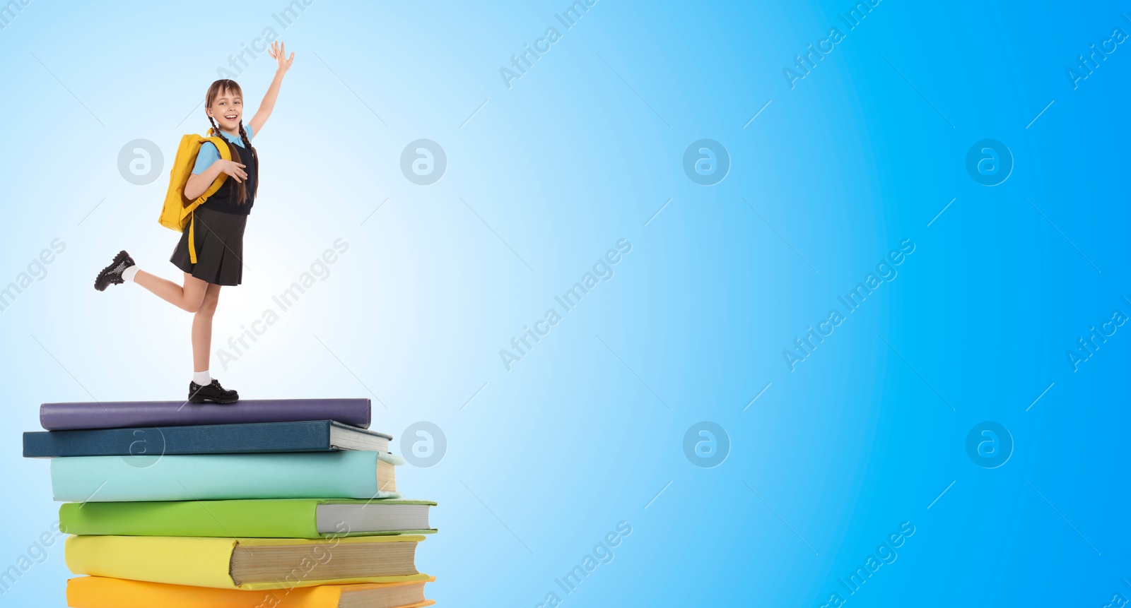 Image of Happy schoolgirl on stack of books on light blue background. Way to knowledge. Banner design with space for text