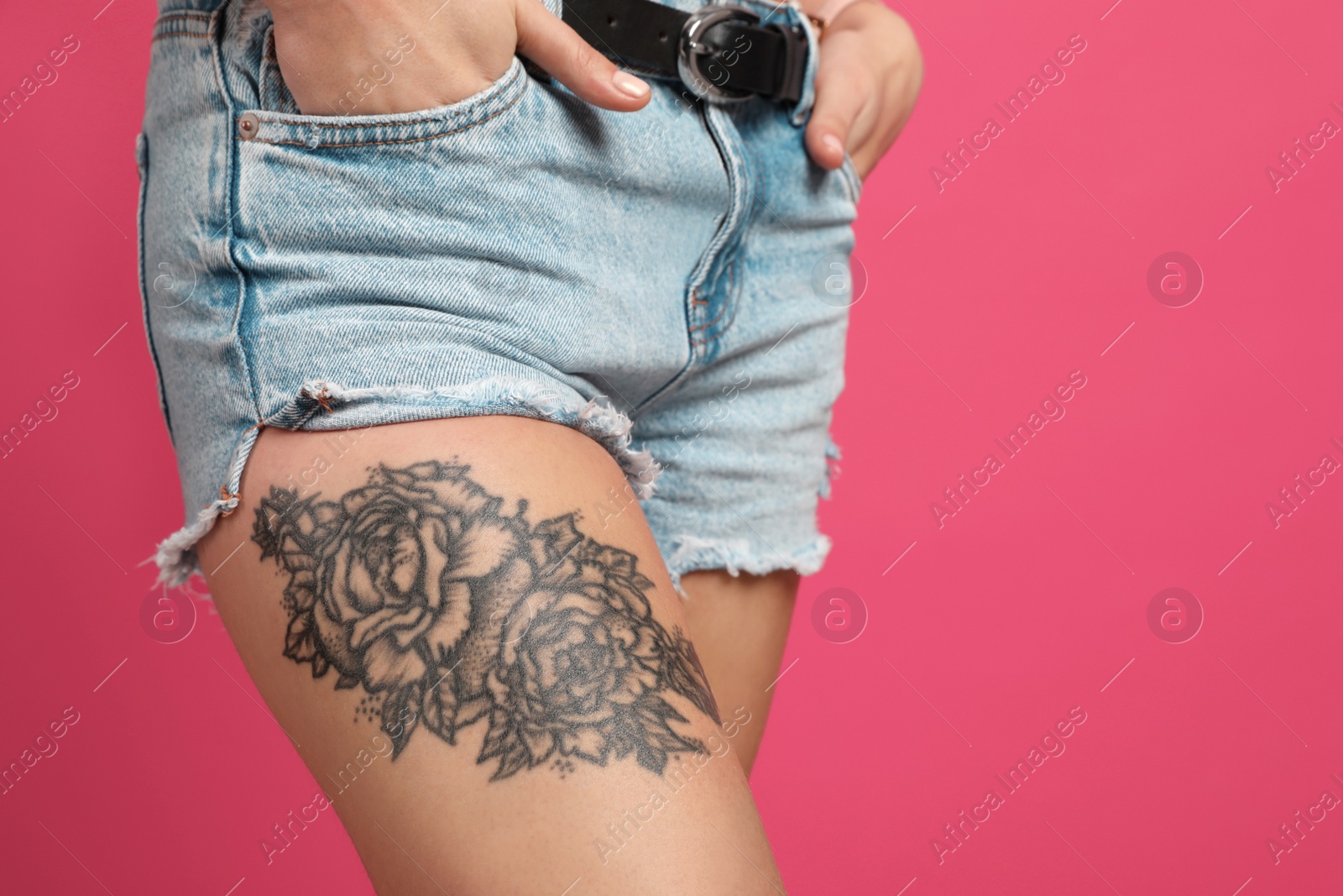 Photo of Woman with tattoo on leg against pink background, closeup. Space for text