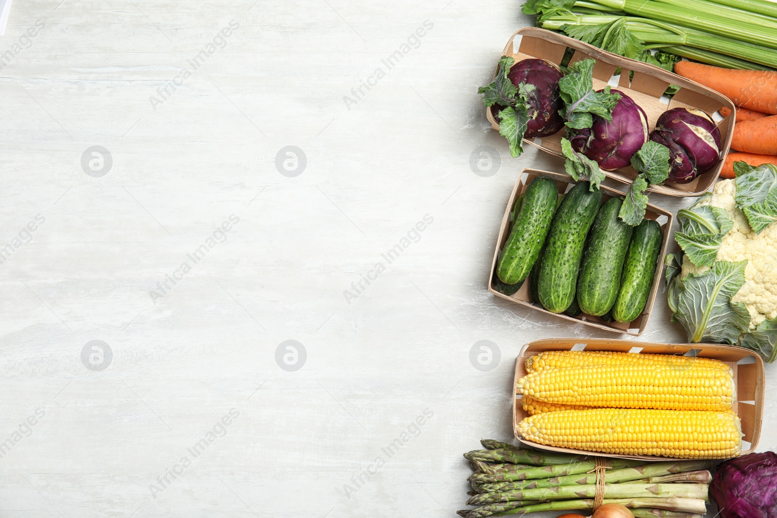 Photo of Flat lay composition with fresh vegetables and space for text on light background