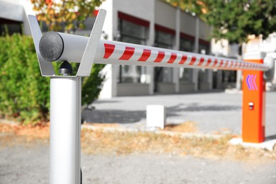 Photo of Closed automatic boom barrier on sunny day outdoors, closeup