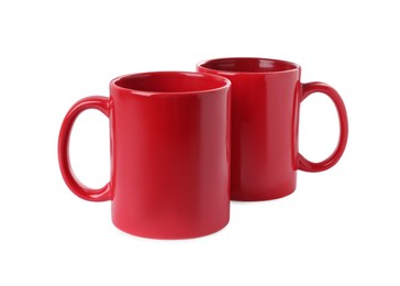 Photo of Two red ceramic mugs isolated on white