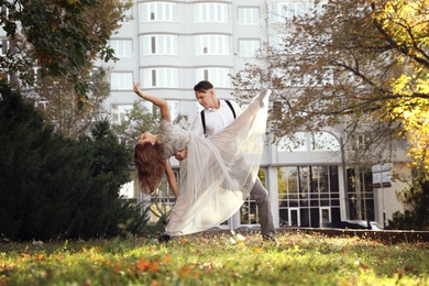 Beautiful young couple practicing dance moves outdoors