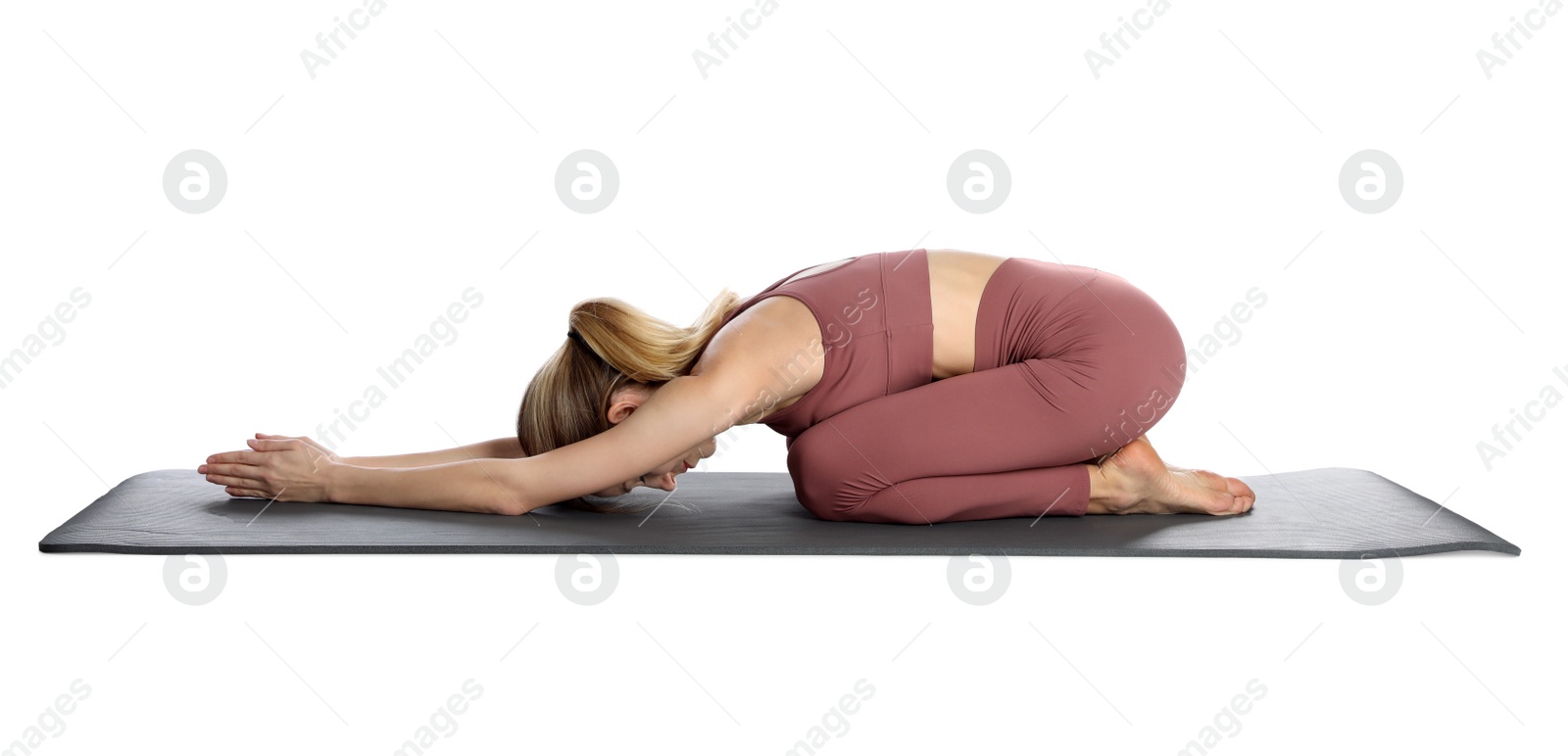 Photo of Young woman in sportswear practicing yoga on white background