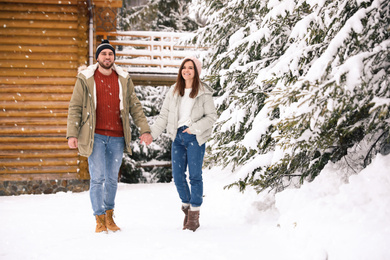 Lovely couple spending time together on snowy day. Winter vacation