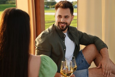 Romantic date. Beautiful couple with glasses of wine on sunny day