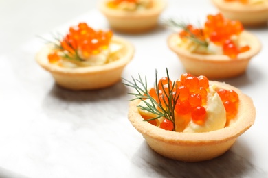 Photo of Delicious canapes with red caviar on table