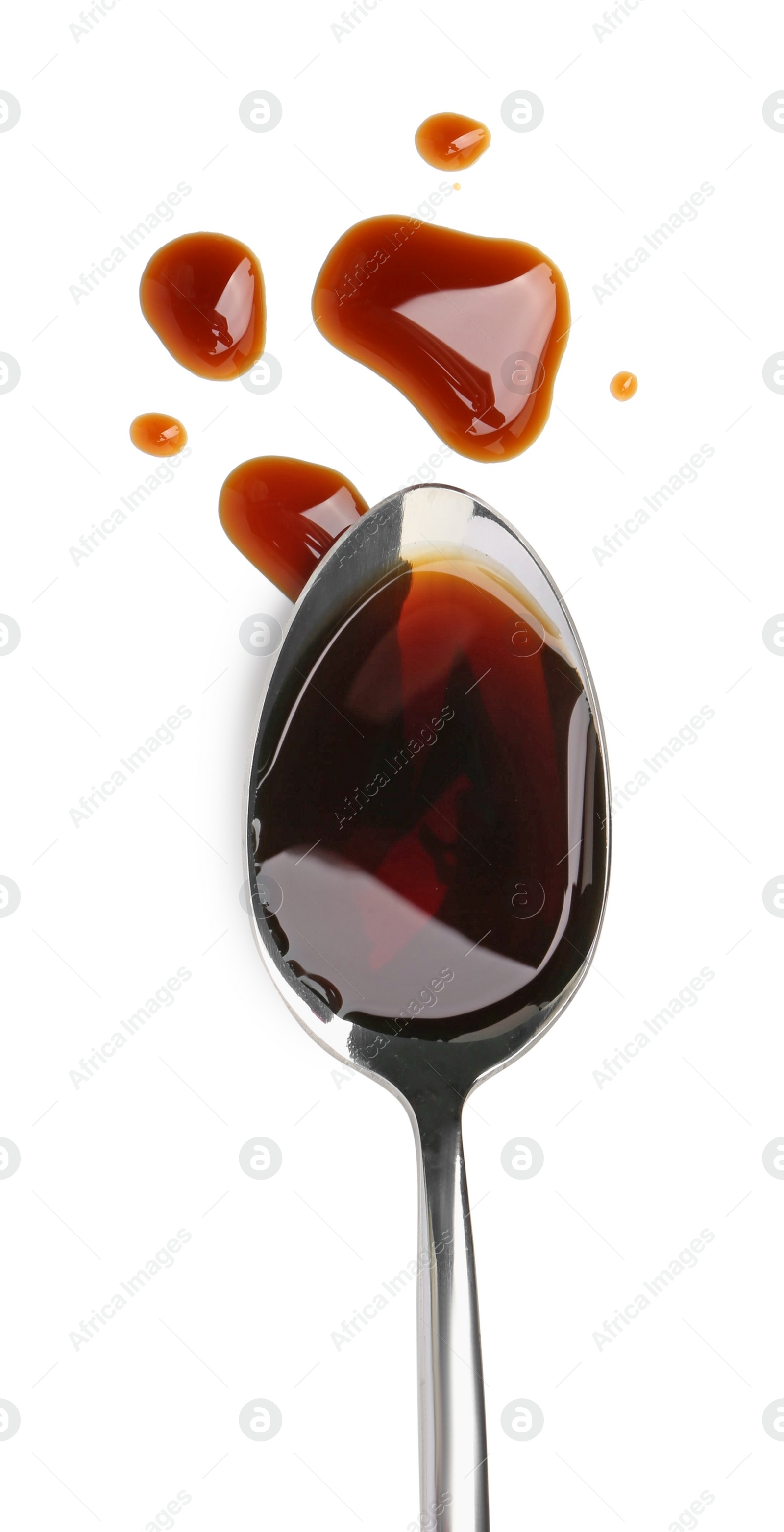 Photo of Tasty soy sauce in spoon isolated on white, top view