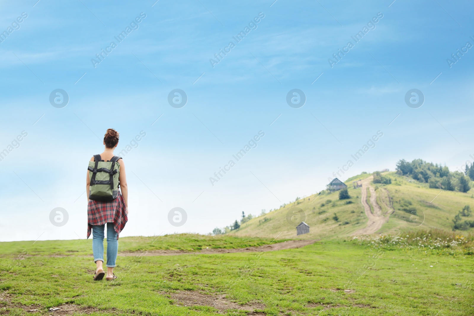 Photo of Woman with backpack in wilderness on cloudy day