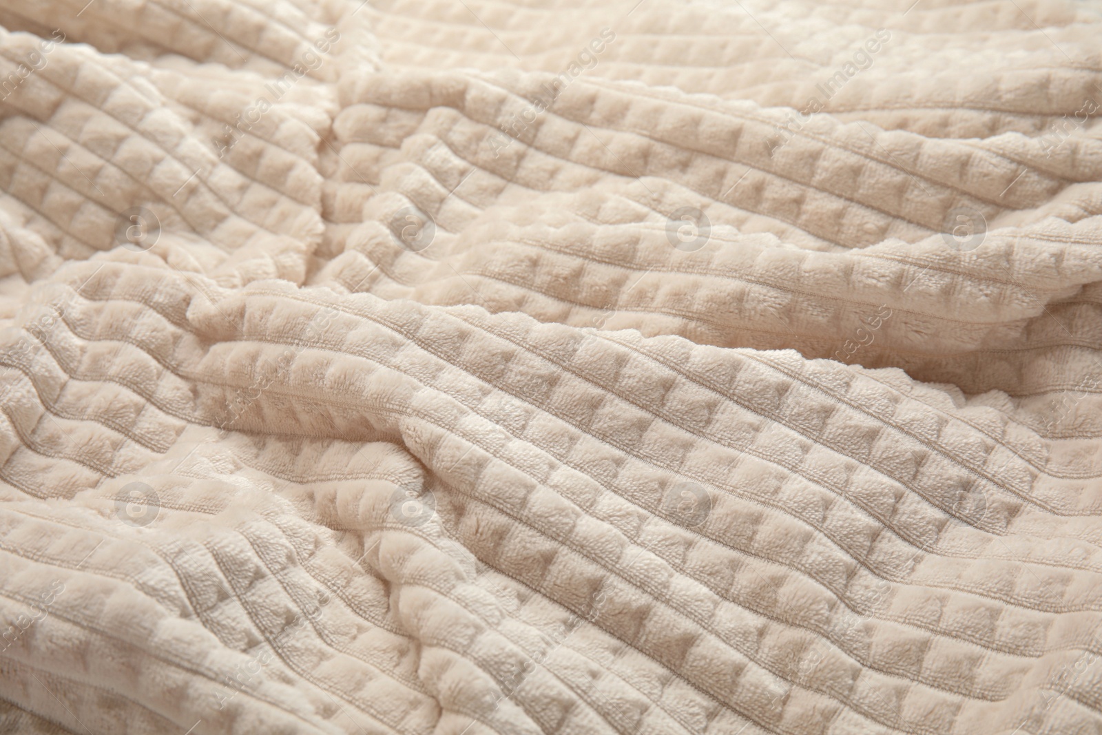 Photo of Soft warm white plaid as background, closeup