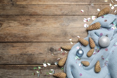 Photo of Flat lay composition with pinecones on wooden background, space for text