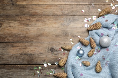 Flat lay composition with pinecones on wooden background, space for text