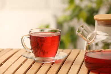 Photo of Delicious hibiscus tea on wooden table indoors
