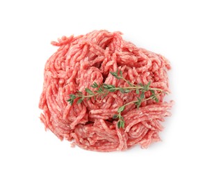 Pile of fresh raw ground meat and thyme isolated on white, top view