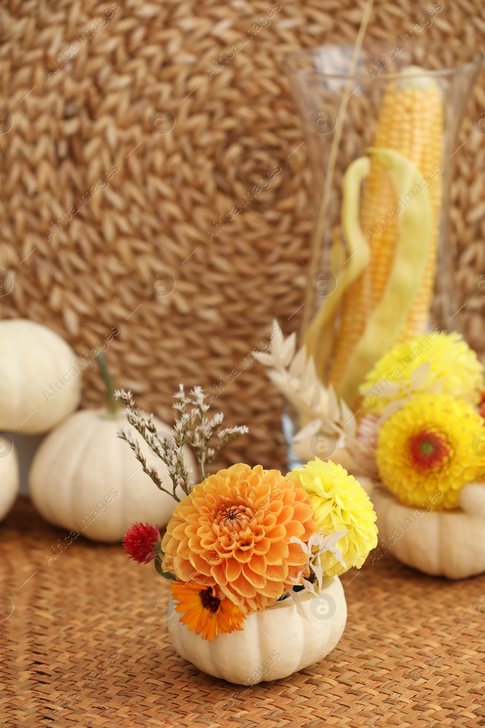 Photo of Small pumpkin with autumn bouquet on table, selective focus