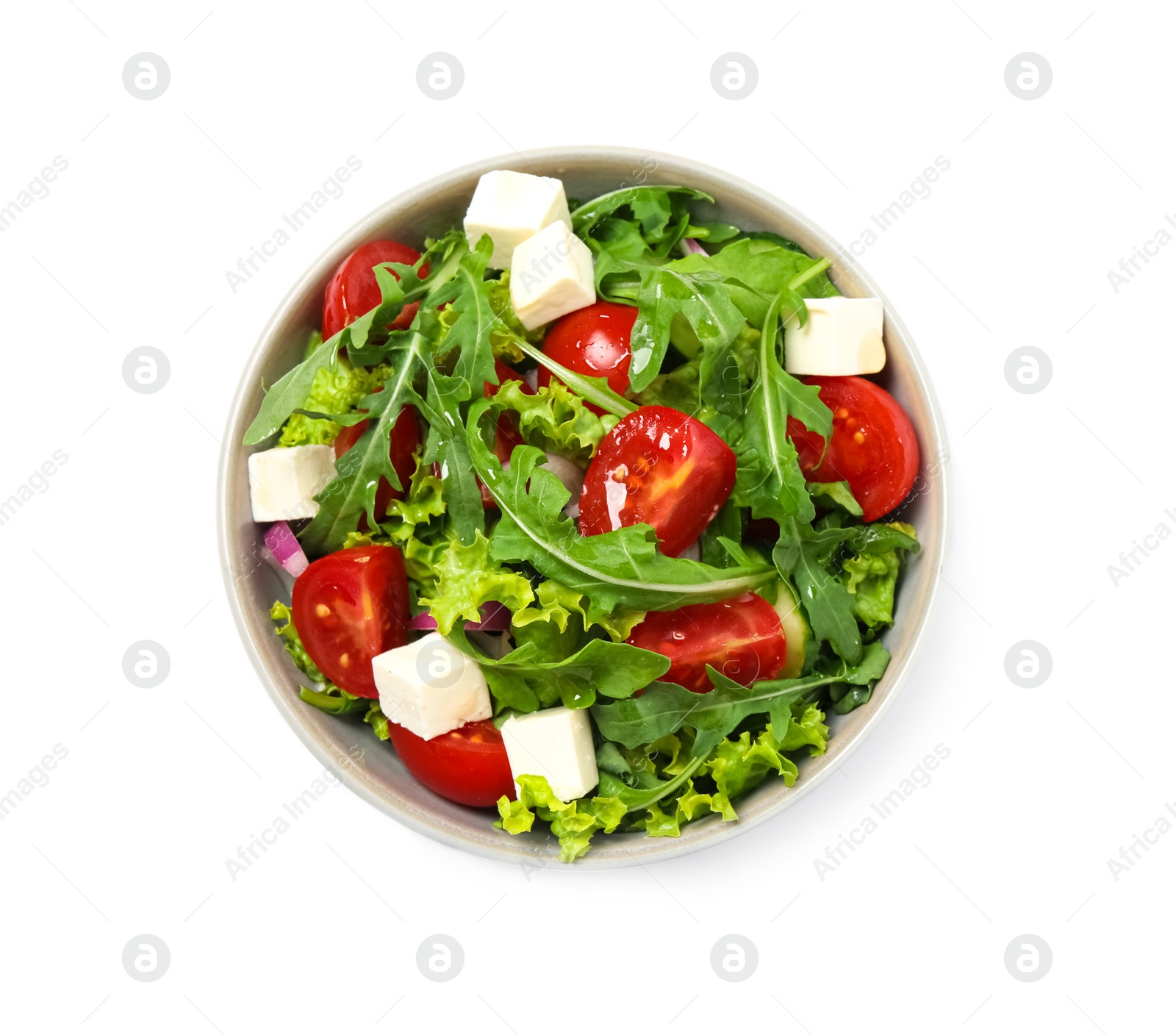 Photo of Delicious salad with arugula and vegetables isolated on white, top view